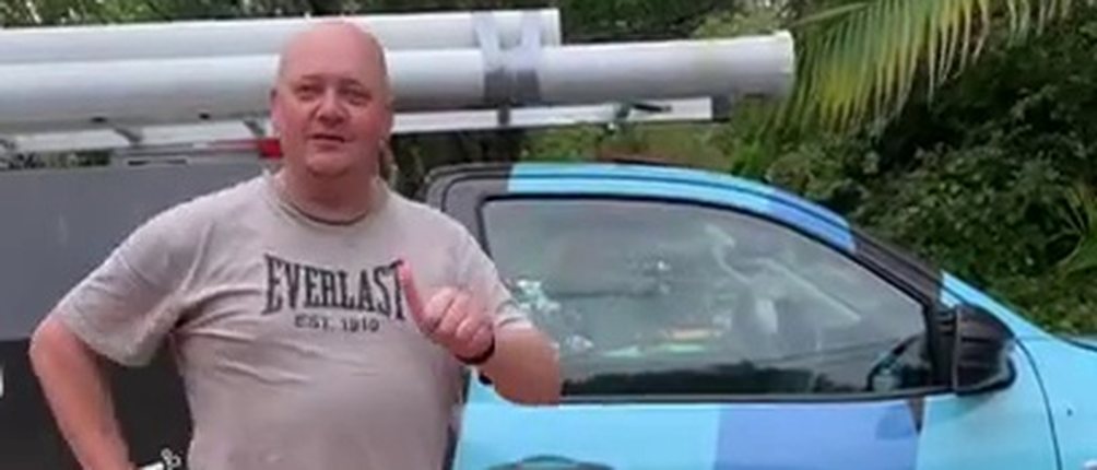 Mr Splash customer beside a Mr Splash Plumbing service van